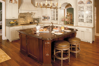 Large tuscan l-shaped medium tone wood floor eat-in kitchen photo in Baltimore with raised-panel cabinets, stainless steel appliances, an island and beige cabinets
