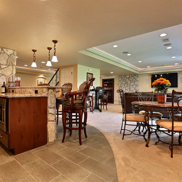 Open Basement Concept in Centennial, CO with tray ceilings and stacked stone