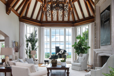 Living room - large rustic open concept medium tone wood floor, brown floor and exposed beam living room idea in Other with white walls, a standard fireplace and a stone fireplace