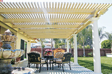 Photo of a mid-sized transitional backyard patio in Salt Lake City with concrete slab and a pergola.