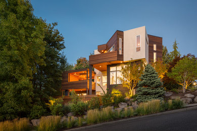 Example of a large trendy multicolored three-story mixed siding house exterior design in Portland