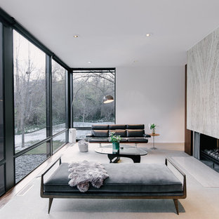 Idéer för att renovera ett stort funkis allrum med öppen planlösning, med vita väggar, heltäckningsmatta, en dubbelsidig öppen spis och en spiselkrans i sten