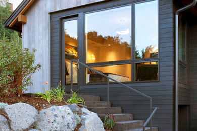 Large contemporary two-storey grey exterior in Denver with wood siding and a gable roof.