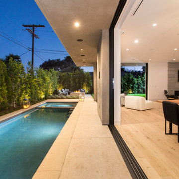 Covered Outdoor Kitchen and Lounge with Poolside Bar Seating