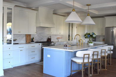 Inspiration for a small modern l-shaped medium tone wood floor, gray floor and tray ceiling eat-in kitchen remodel with a farmhouse sink, louvered cabinets, white cabinets, quartzite countertops, white backsplash, stone slab backsplash, white appliances, an island and white countertops