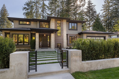 Large contemporary gray three-story mixed siding exterior home idea in Vancouver with a hip roof