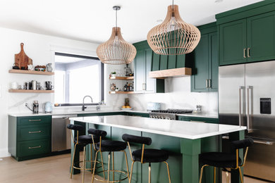 Inspiration for a large country l-shaped eat-in kitchen remodel in Toronto with an undermount sink, green cabinets, quartz countertops, white backsplash, quartz backsplash, stainless steel appliances, an island and white countertops