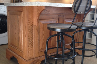 Eat-in kitchen - mid-sized traditional l-shaped porcelain tile eat-in kitchen idea in Toronto with a farmhouse sink, raised-panel cabinets, distressed cabinets, quartz countertops, white backsplash, porcelain backsplash, white appliances and an island