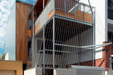This is an example of a contemporary three-storey exterior in Melbourne with metal siding.