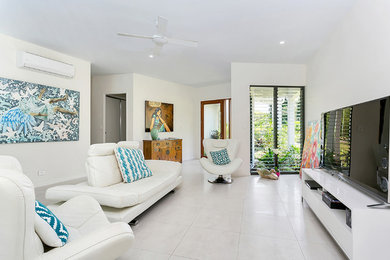 Mid-sized contemporary open concept living room in Cairns with white walls, porcelain floors and a freestanding tv.