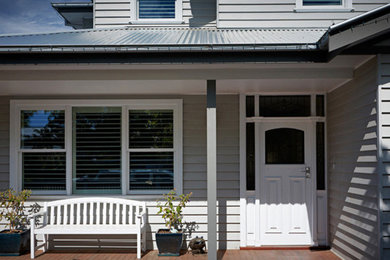 Design ideas for a large traditional two-storey grey exterior in Melbourne with wood siding.