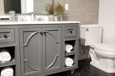 Bathroom - small farmhouse master gray tile and porcelain tile ceramic tile and black floor bathroom idea in Los Angeles with furniture-like cabinets, gray cabinets, a two-piece toilet, gray walls, an undermount sink, marble countertops, a hinged shower door and white countertops