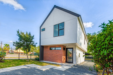 Example of a mid-sized trendy white two-story mixed siding exterior home design in Other with a metal roof