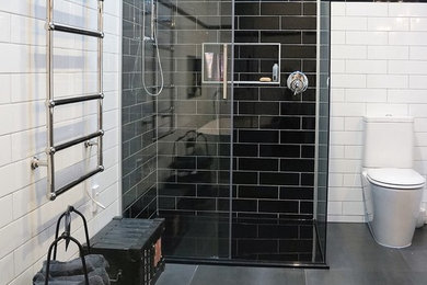 This is an example of a mid-sized traditional master bathroom in Christchurch with a freestanding tub, black and white tile, subway tile and porcelain floors.