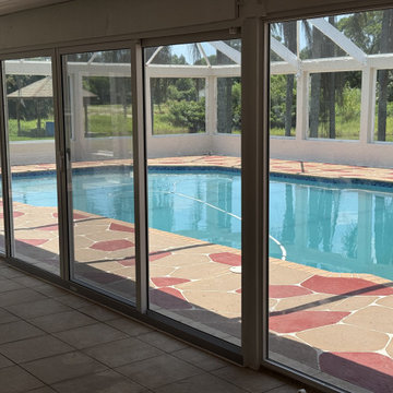 Full installation of custom impact-rated sliding glass doors patio enclosure