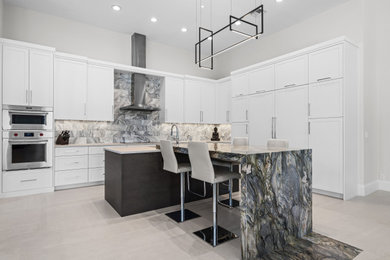 This is an example of an expansive contemporary l-shaped open plan kitchen in Miami with an undermount sink, shaker cabinets, white cabinets, quartzite benchtops, multi-coloured splashback, marble splashback, panelled appliances, porcelain floors, with island, beige floor and white benchtop.