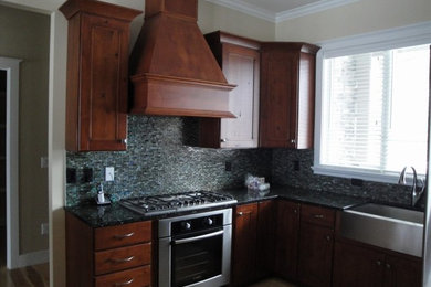 Example of a mid-sized classic l-shaped eat-in kitchen design in Other with recessed-panel cabinets, granite countertops and no island