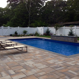 Inspiration for a mid-sized transitional backyard stone and rectangular pool remodel in New York