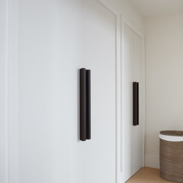 White & Oak Laundry Closet with Oversized Black Pulls