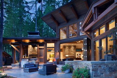 Patio kitchen - mid-sized rustic backyard stone patio kitchen idea in Other with no cover