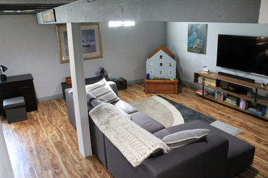 Small urban underground vinyl floor basement photo in Columbus with gray walls