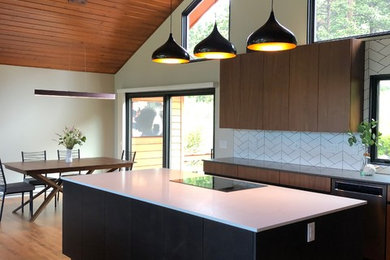 This is an example of a large contemporary l-shaped eat-in kitchen in Denver with an undermount sink, flat-panel cabinets, dark wood cabinets, quartzite benchtops, white splashback, ceramic splashback, panelled appliances, medium hardwood floors, with island, brown floor and white benchtop.