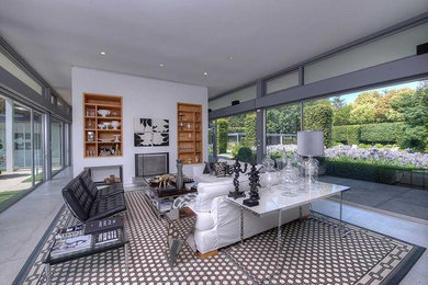 Living room - large contemporary formal and open concept concrete floor and gray floor living room idea in San Francisco with white walls, a two-sided fireplace, a wood fireplace surround and no tv