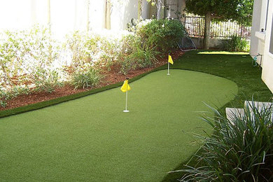 This is an example of a mid-sized tropical full sun backyard outdoor basketball/tennis/multi-game court in Los Angeles.