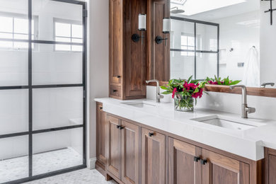 Bathroom - mid-sized transitional master white tile and subway tile mosaic tile floor, white floor and double-sink bathroom idea in Philadelphia with shaker cabinets, brown cabinets, gray walls, an undermount sink, quartz countertops, white countertops and a built-in vanity