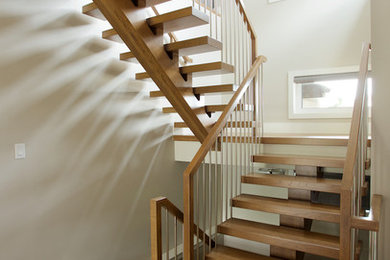 Inspiration for a contemporary wood straight staircase in Edmonton with open risers.