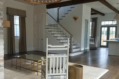 Example of a large transitional open concept medium tone wood floor and brown floor living room design in New Orleans with white walls, a standard fireplace, a brick fireplace and no tv