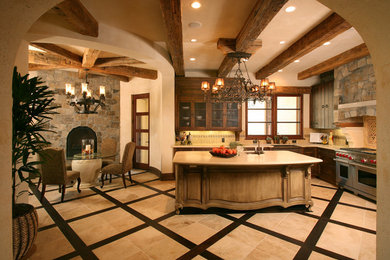 Inspiration for a kitchen remodel in San Francisco with glass-front cabinets, stainless steel appliances and an island