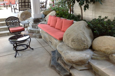 Example of a large classic backyard concrete paver patio kitchen design in Other with a gazebo