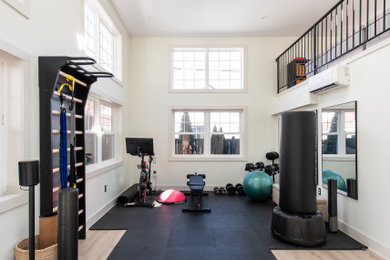 Example of a large trendy vinyl floor and beige floor home weight room design in DC Metro with white walls