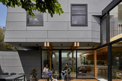 This is an example of a large contemporary backyard patio in Melbourne with decking and a roof extension.