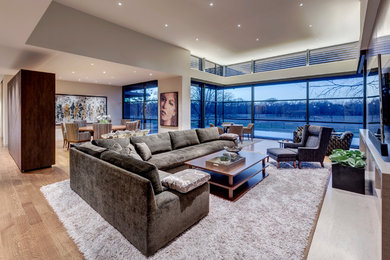 Living room - large modern open concept medium tone wood floor living room idea in Dallas with white walls, a standard fireplace, a stone fireplace and a wall-mounted tv