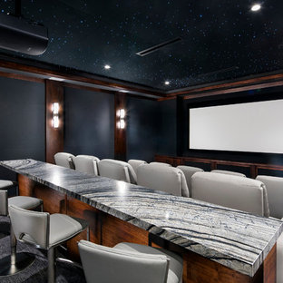 Inspiration for a contemporary carpeted home theater remodel in Las Vegas with black walls and a projector screen