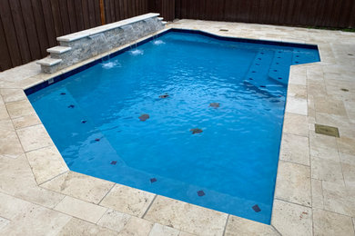 Example of a large island style backyard concrete paver and custom-shaped aboveground pool house design in Dallas