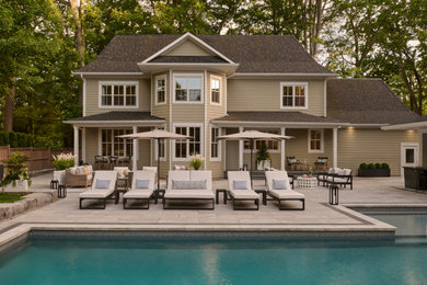 Beach style backyard concrete paver patio photo in Toronto with a fire pit