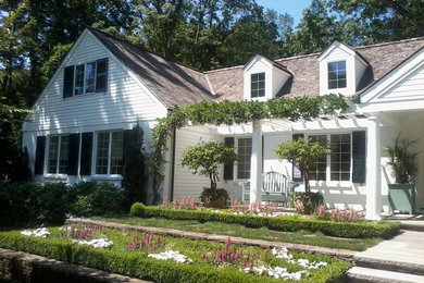 Example of a large classic white two-story wood exterior home design in New York with a shingle roof