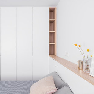 Idéer för ett stort nordiskt huvudsovrum, med vita väggar, bambugolv och brunt golv