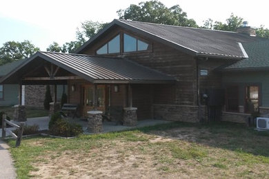 Large mountain style three-story wood exterior home photo in Kansas City