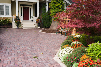 Inspiration for a mid-sized farmhouse full sun front yard brick landscaping in Toronto for spring.