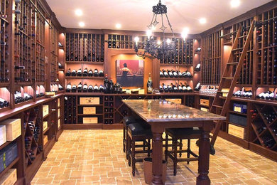 This is an example of an expansive traditional wine cellar in New York with travertine floors, storage racks and beige floor.