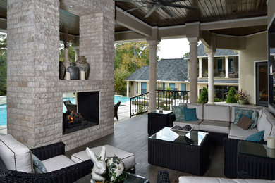 Large transitional backyard verandah in Houston with a fire feature and a roof extension.
