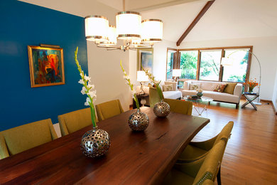 Dining room - large modern light wood floor dining room idea in Cleveland with white walls