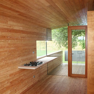 Mid-sized contemporary kitchen pantry inspiration - Kitchen pantry - mid-sized contemporary galley light wood floor kitchen pantry idea in Venice with flat-panel cabinets, light wood cabinets, wood countertops, no island, a single-bowl sink and wood backsplash