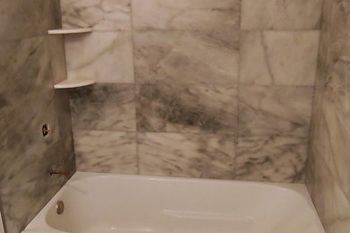 Example of a mid-sized minimalist beige tile and marble tile marble floor and beige floor bathroom design in Chicago