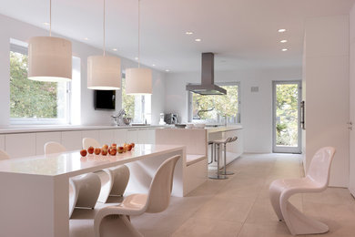 Inspiration for a large contemporary galley eat-in kitchen remodel in Other with flat-panel cabinets, white cabinets and an island