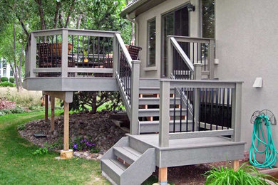Example of a mid-sized classic backyard deck design in Denver with no cover